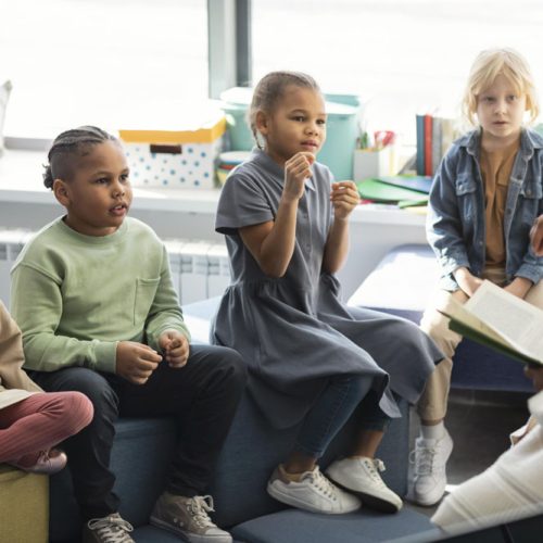 female-teacher-reading-her-pupils